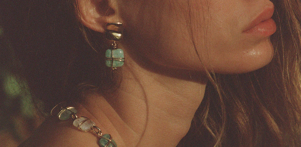 Model wearing a Gas Bijoux gold drop earring