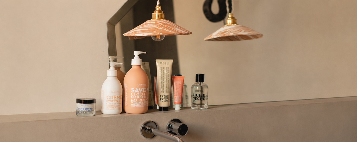 Compagnie de Provence hand and body cream bottles on a shelf